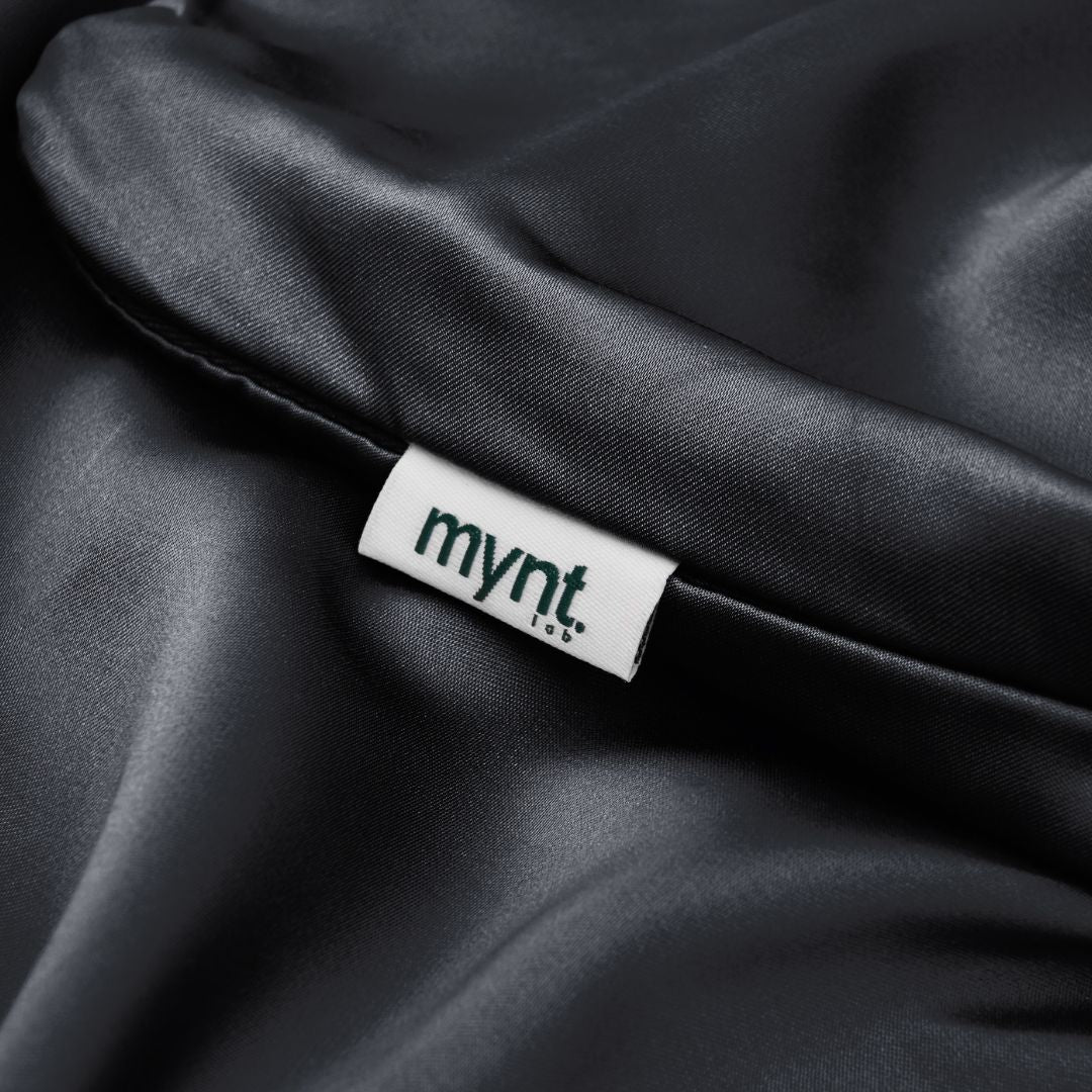 Close-up of black silky pillowcase with Mynt Lab label