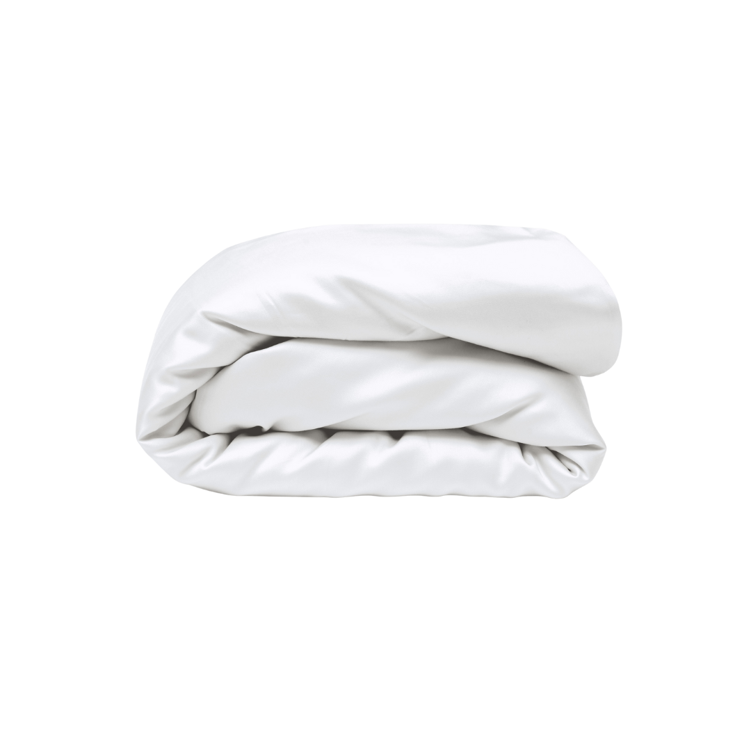 A neatly folded, plain white comforter or duvet on a light gray background.