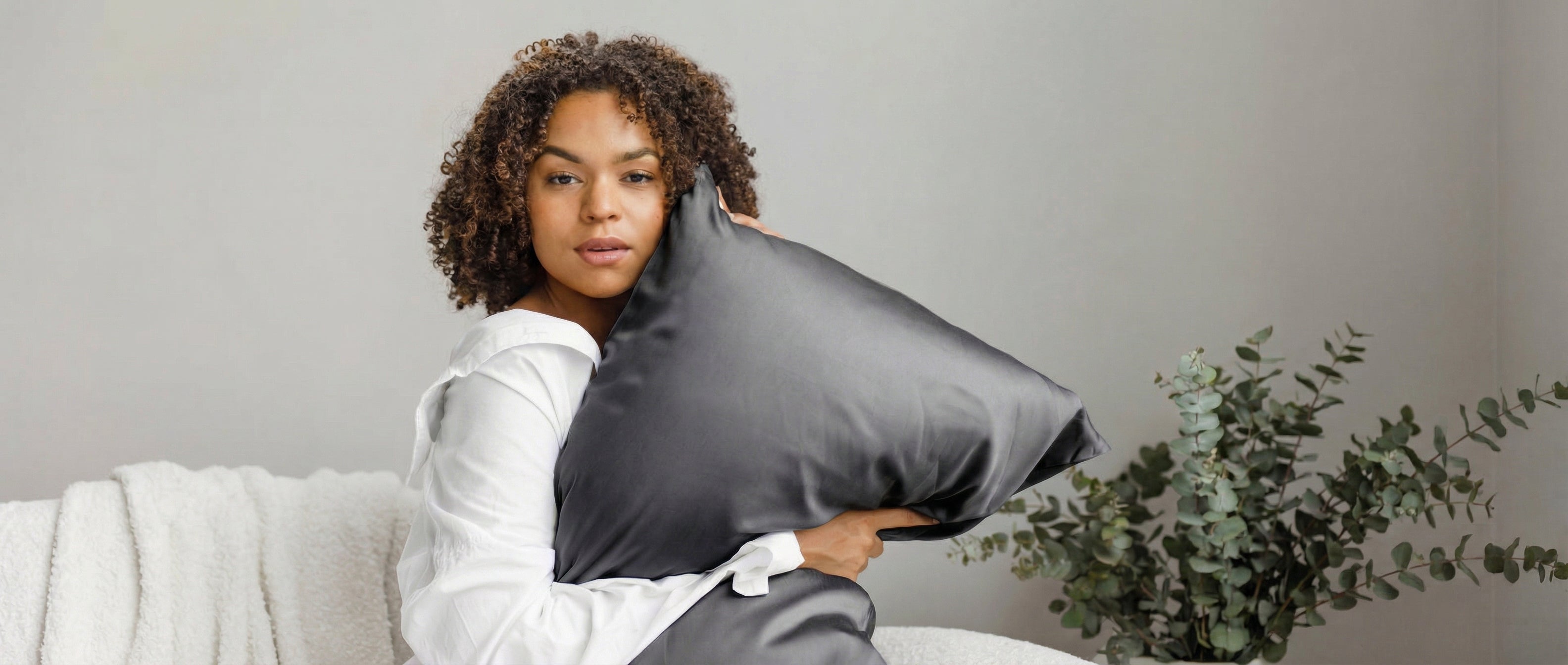 A light green rectangular pillow with smooth, plain fabric, displayed against a white background.