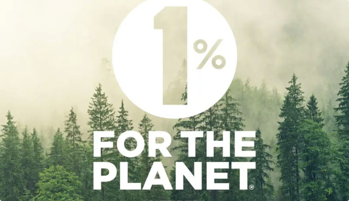 Large white text reading 1% FOR THE PLANET overlays a background of evergreen trees and mist, emphasizing an environmental initiative.