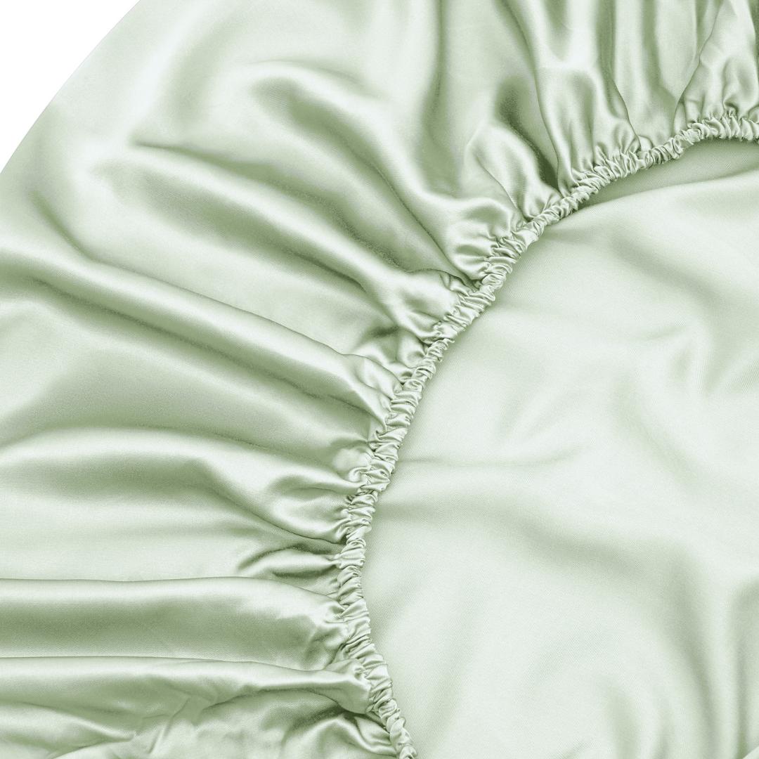 Close-up of the Fitted Sheet Set in sage green, featuring gathered elasticised edges and a smooth, shiny texture - ideal for those who love silky soft sheets.