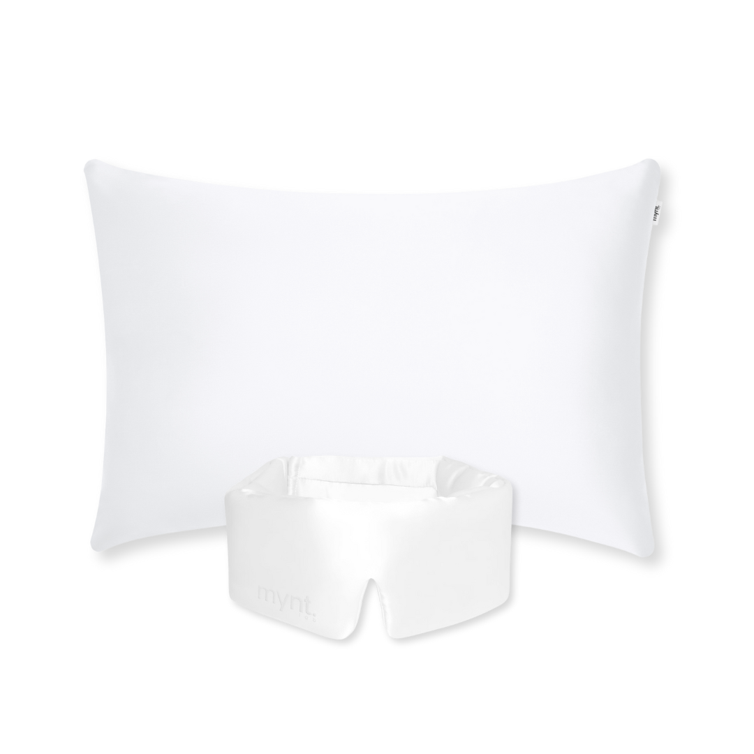 The Deep Sleep Bundle features a rectangular white pillow with a cooling pillowcase and a matching satin face cradle cover, all displayed on a light gray background—ideal for achieving deep sleep.