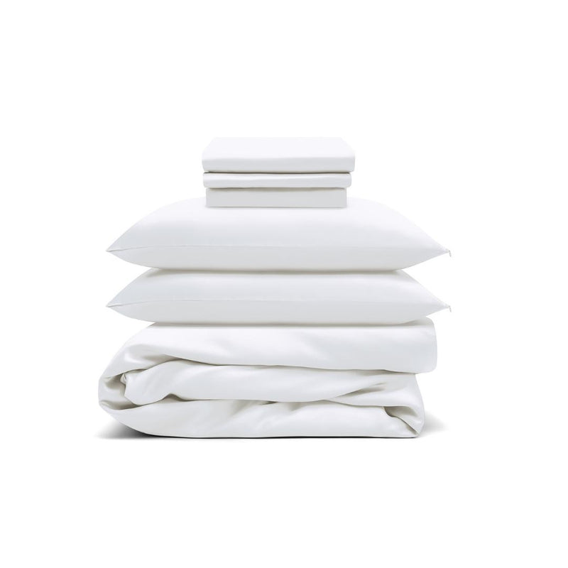The Bedding Bundle features white antibacterial bedding: two folded sheets, two pillows with pillowcases, and a folded duvet, all neatly stacked against a white background.