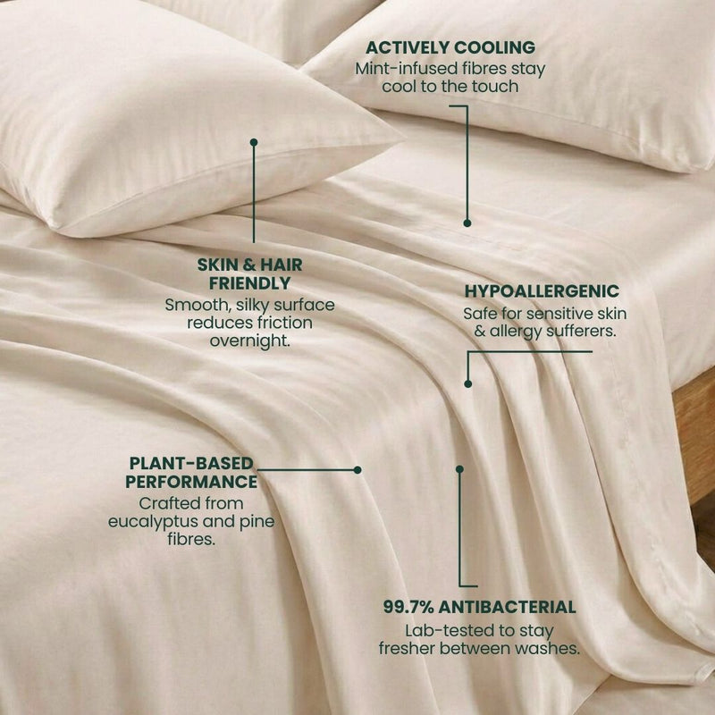 A neatly made bed featuring the Mynt Lab MyntFusion™ Complete Sheet Set (5-piece) in cream - actively cooling, plant-based, hypoallergenic bedding that’s gentle on skin and hair and 99.7% antibacterial.