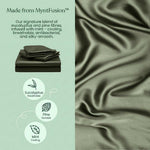 A stack of Mynt Lab’s MyntFusion™ Fitted Sheet Set in green beside silky fabric, offering cooling, breathable, and hypoallergenic comfort— - deal for hot sleepers with eucalyptus, pine, and mint fibres.