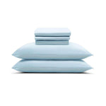 The Mynt Lab MyntFusion™ Complete Sheet Set (4-Piece) features silky soft, light blue sheets and pillowcases, neatly stacked with two pillows at the bottom and folded sheets on top, displayed against a white background.