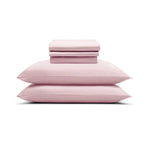 The MyntFusion™ Complete Sheet Set (4-Piece) by Mynt Lab, shown in light pink with pillowcases and sheets neatly stacked on a white background, is perfect for hot sleepers.