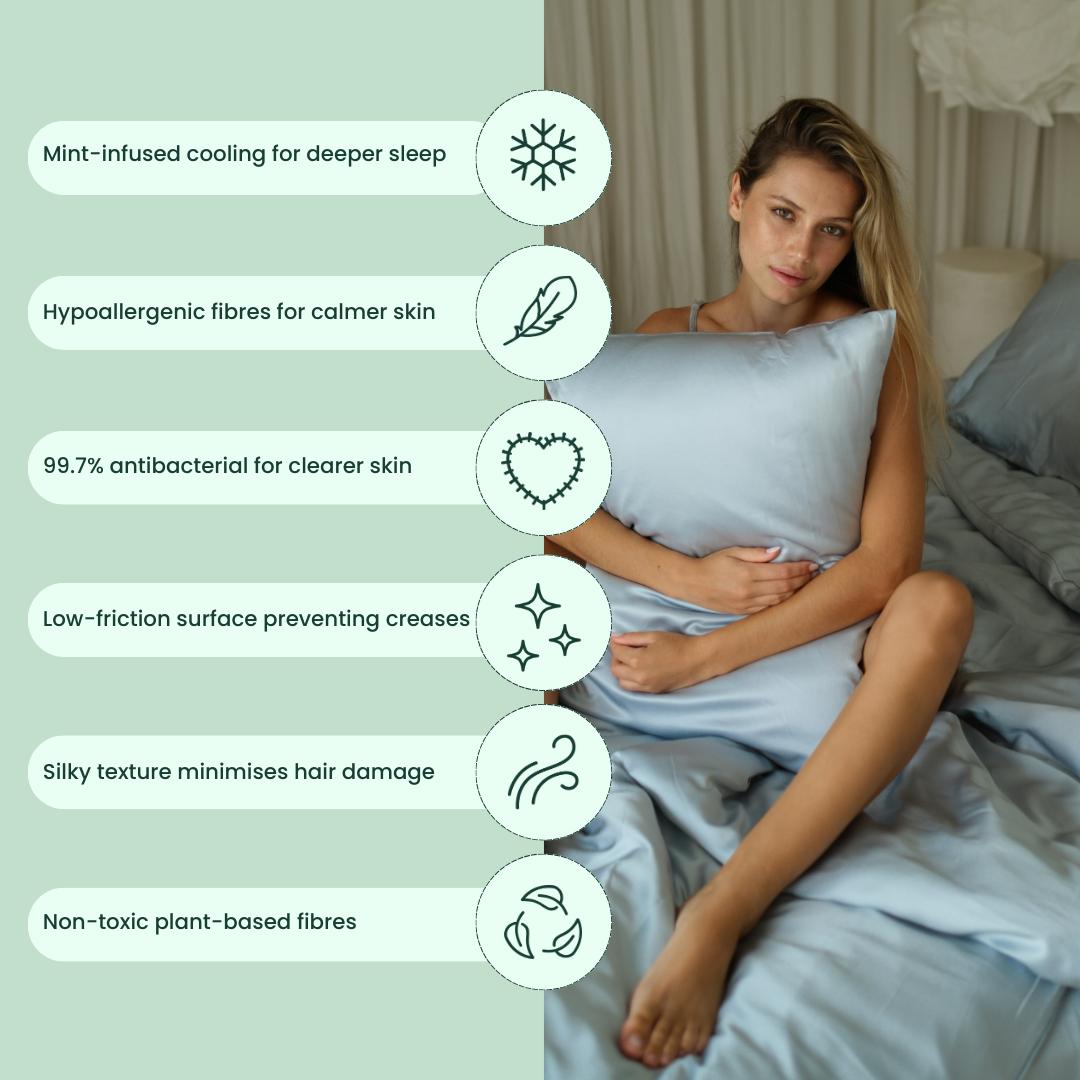 A woman sits on a bed embracing the mynt lab powder blue pillowcase, with icons and text showcasing its cooling, hypoallergenic, antibacterial qualities, silky texture, deep sleep benefits, and non-toxic plant-based fibres.