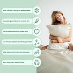 A woman sits on a bed holding the Deep Sleep Bundle pillowcase, with icons showing its mint-infused cooling, hypoallergenic and antibacterial features, silky plant-based fibres, and non-toxic materials - ideal for deep sleep.