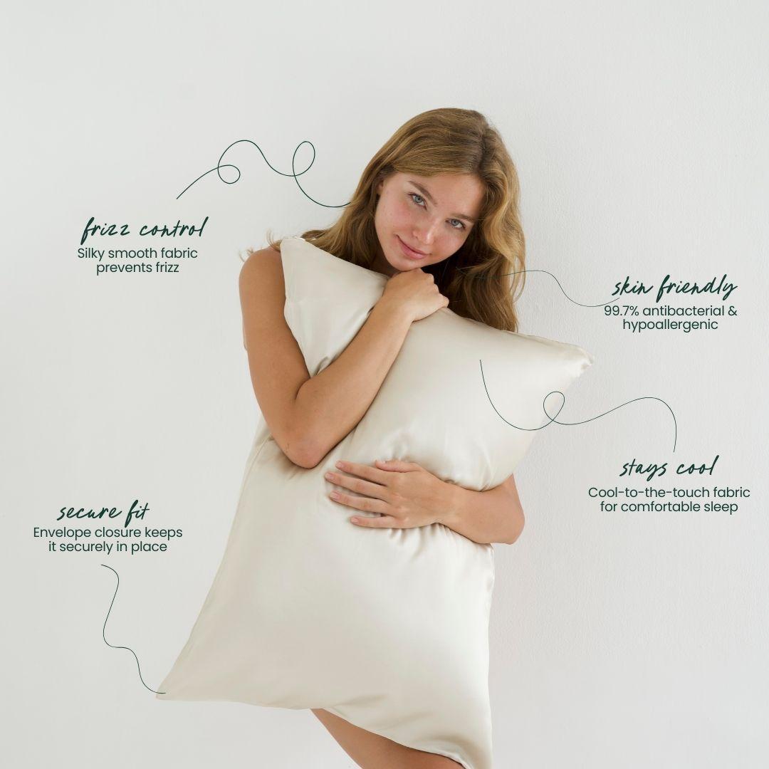 Woman holding a sand-coloured silky pillow with text about its features on a neutral background