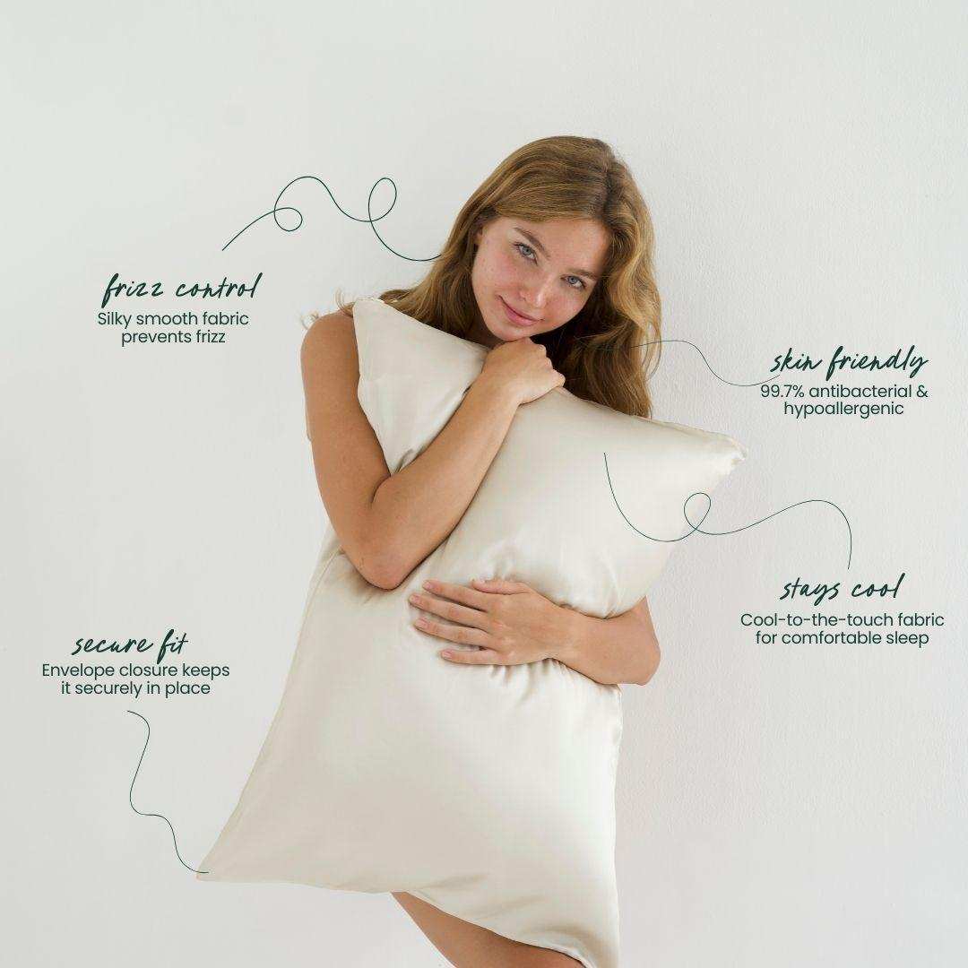 Woman holding a sand-coloured silky pillow with text about its features on a neutral background