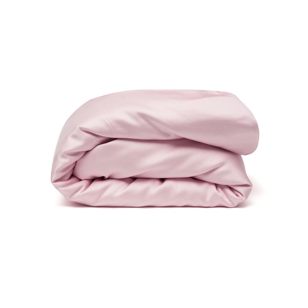 A neatly folded light pink Duvet Cover is set against a plain white background.