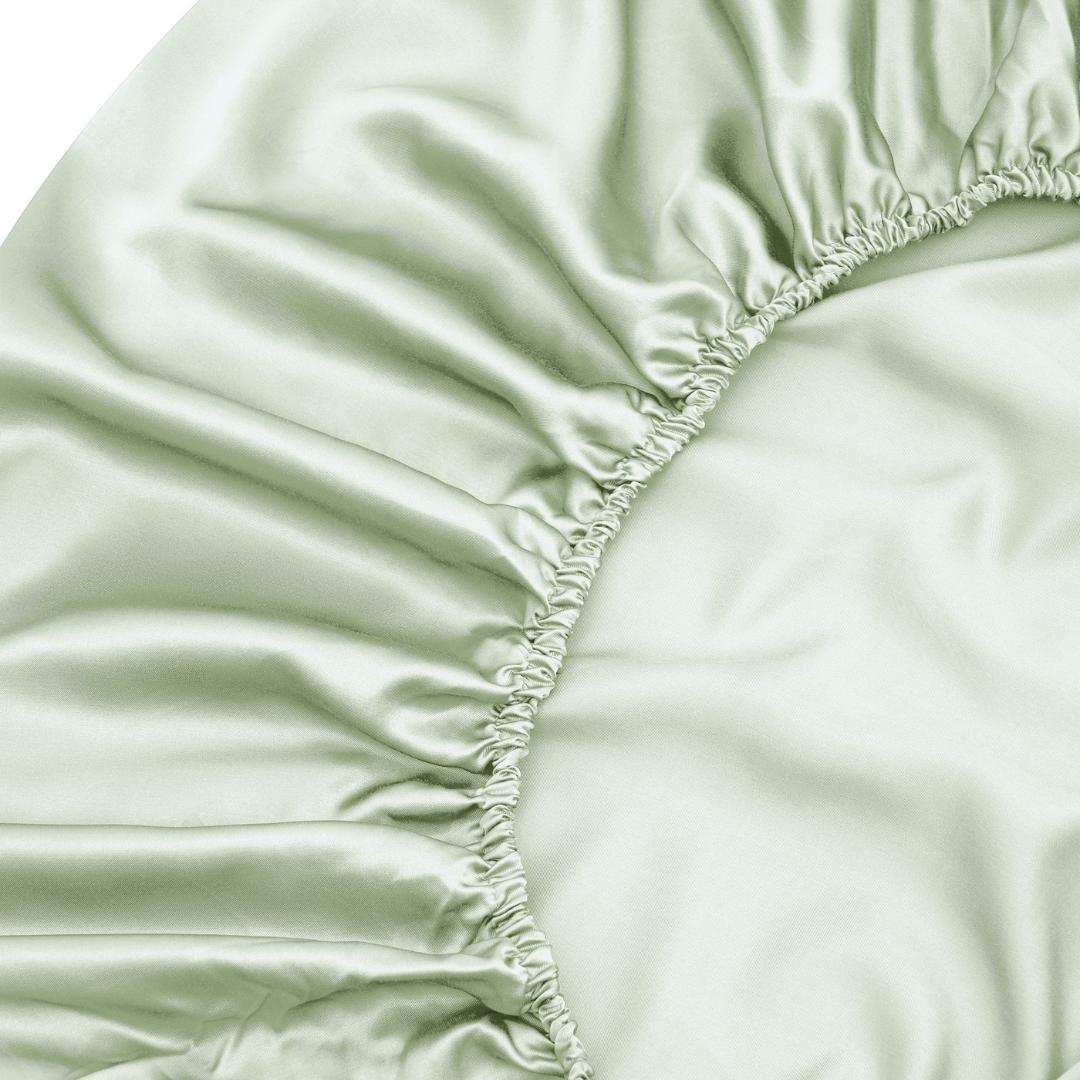 Close-up of the Fitted Sheet Set in sage green, featuring gathered elasticised edges and a smooth, shiny texture - ideal for those who love silky soft sheets.