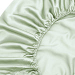 Close-up of the Fitted Sheet Set in sage green, featuring gathered elasticised edges and a smooth, shiny texture - ideal for those who love silky soft sheets.