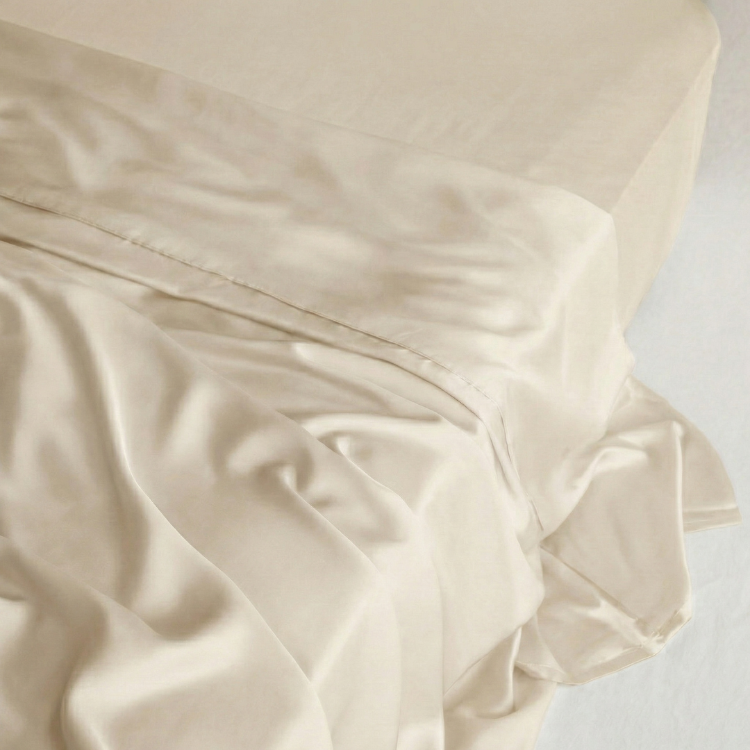 Silky smooth, Sand MyntFusion™ flat sheet draped over a bed, showcasing its cooling fabric.
