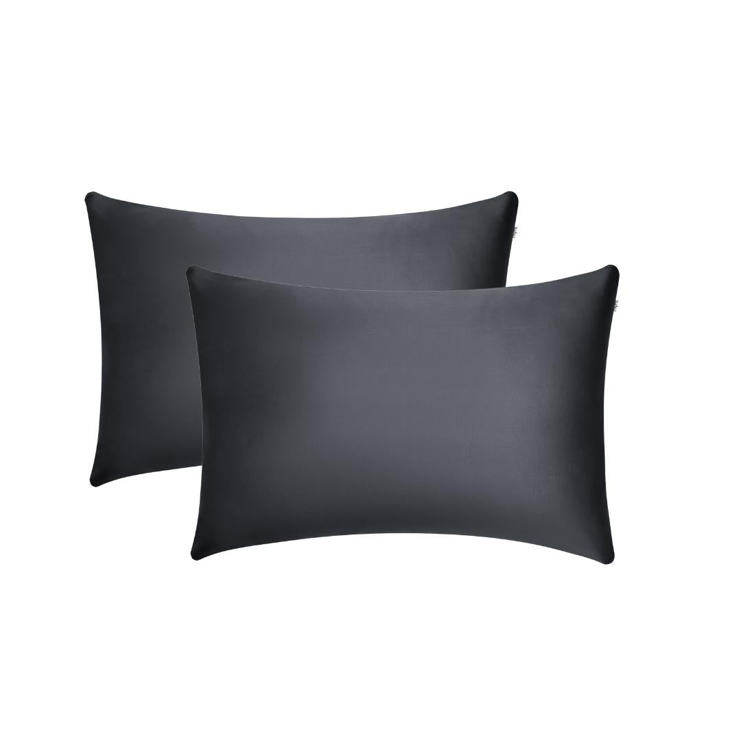 Two black pillowcases are stacked slightly offset against a plain white background, offering a sleek look that enhances beauty sleep and helps reduce frizz.