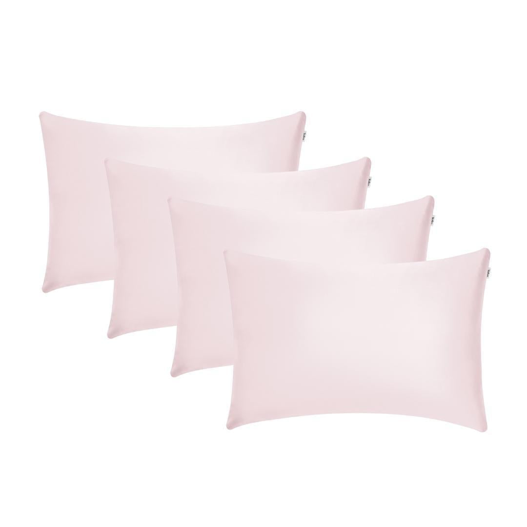 Four light pink rectangular pillowcases arranged in two slightly overlapping rows against a white background - perfect for beauty sleep and keeping your skin hydrated.