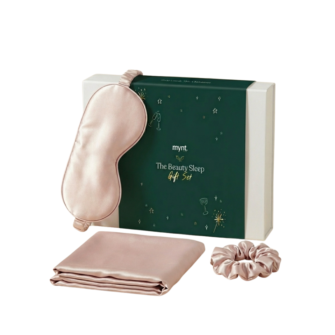 The Beauty Sleep Gift Set includes a blush pink silky sleep mask, matching pillowcase, and scrunchie - MyntFusion essentials designed for restful sleep, all beautifully arranged in a chic boxed set.