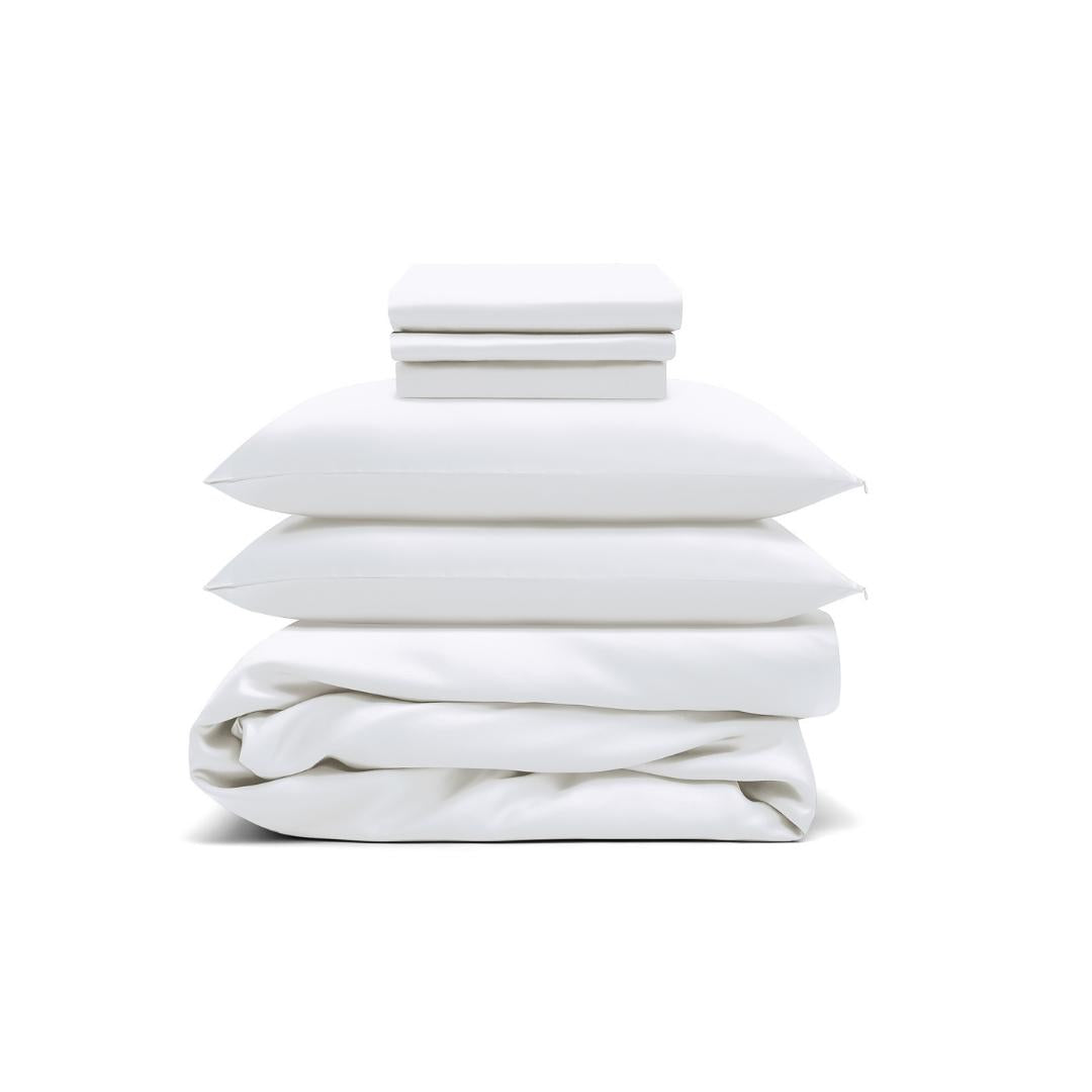 The Bedding Bundle features white antibacterial bedding: two folded sheets, two pillows with pillowcases, and a folded duvet, all neatly stacked against a white background.