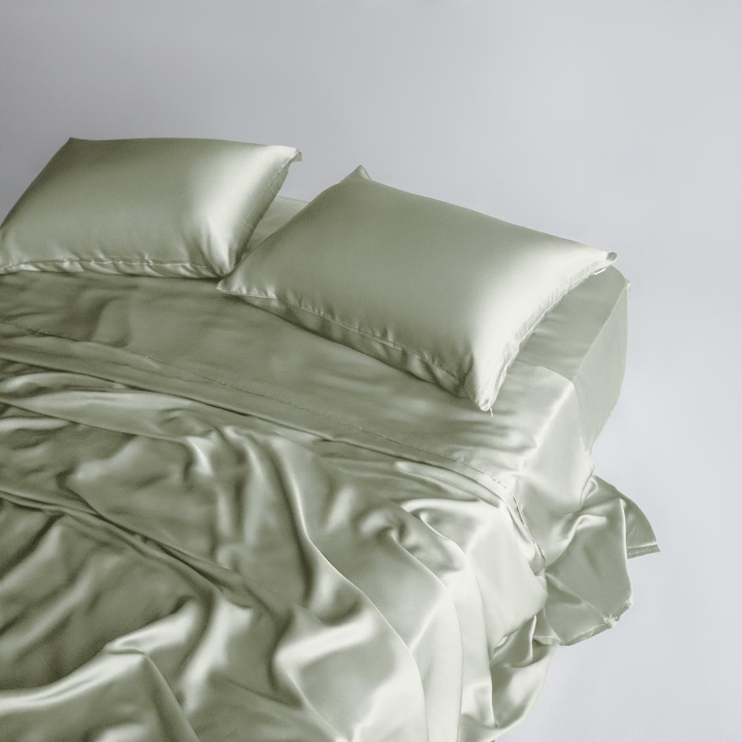 The Mynt Lab MyntFusion™ Complete Sheet Set (4-Piece) features light green, silky-soft sheets and two matching pillows for a smooth, shiny, and luxurious look against a plain white background.