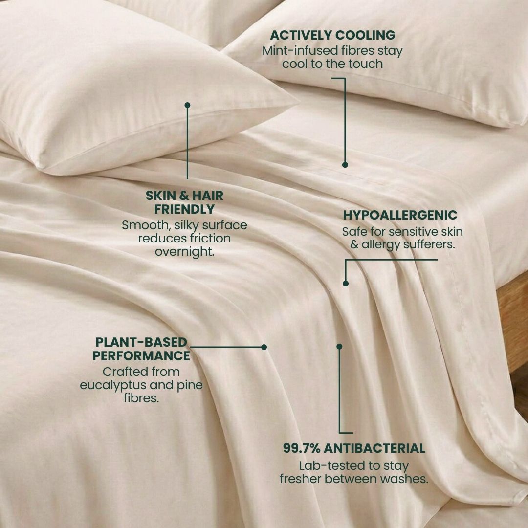 A neatly made bed featuring the Mynt Lab MyntFusion™ Complete Sheet Set (5-piece) in cream - actively cooling, plant-based, hypoallergenic bedding that’s gentle on skin and hair and 99.7% antibacterial.