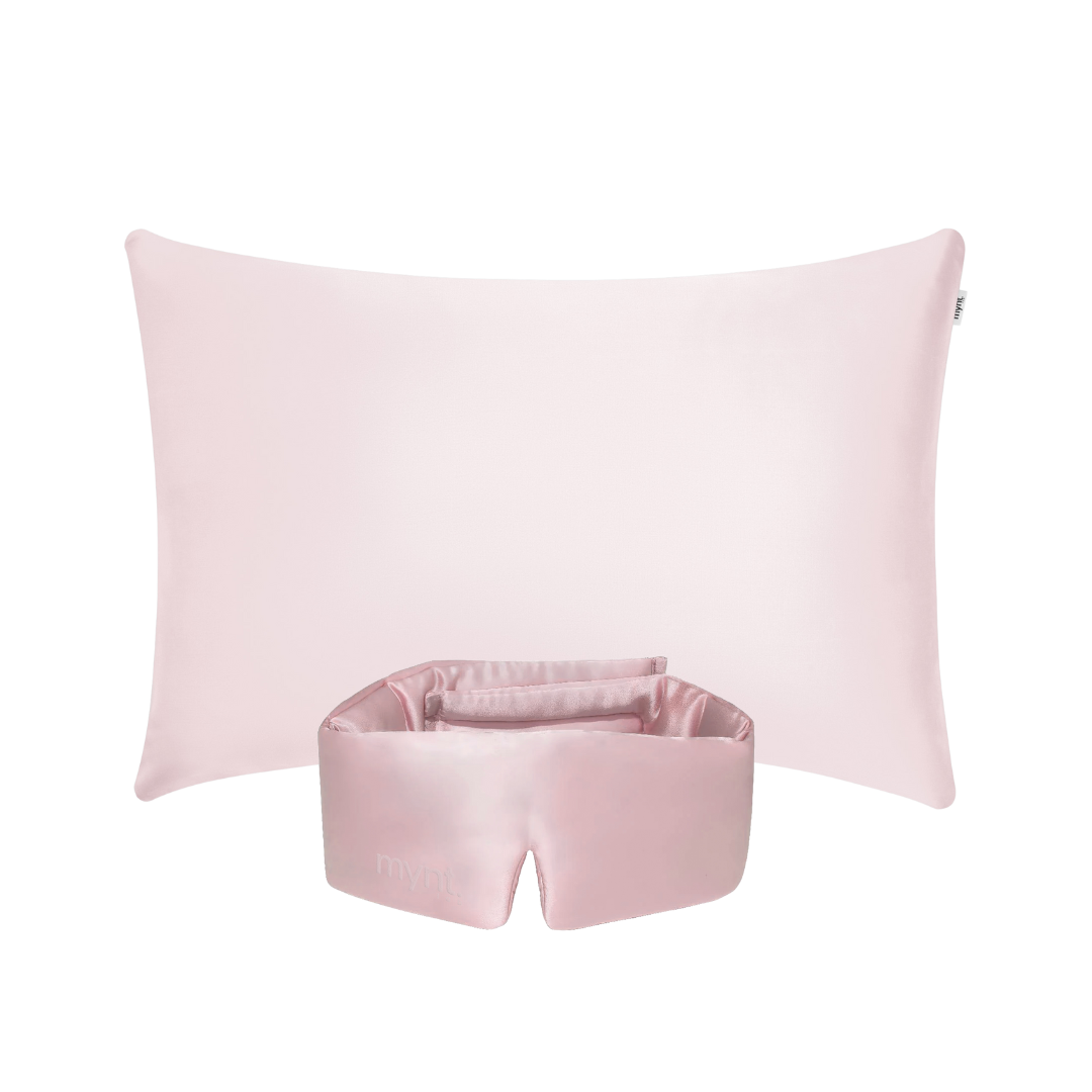 The Deep Sleep Bundle, featuring a light pink cooling pillowcase and matching pink silky blackout sleep mask, is displayed against a white background - ideal for deep sleep.