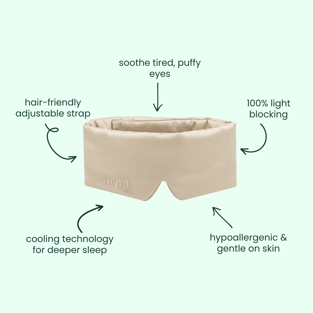 A sand blackout sleep mask offering 100% light blocking, cooling tech for deeper sleep, hypoallergenic and gentle fabric, hair-friendly adjustable strap, and soothing relief for tired or puffy eyes.