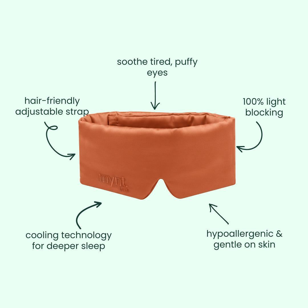 The Deep Sleep Bundle includes a terracotta coloured blackout sleep mask with a hair-friendly adjustable strap, cooling technology, 100% light blocking, hypoallergenic material, and soothing comfort for tired eyes. Perfect for deep sleep. Background: light green.