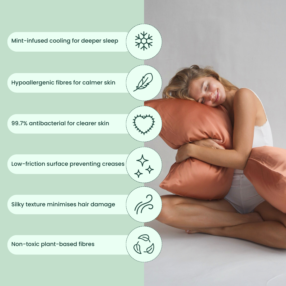 A woman in white sleepwear hugs a terracotta coloured, cooling pillowcase, smiling. Next to her, icons and text highlight its deep sleep support, hypoallergenic and antibacterial fabric, silky feel, and plant-based fibres.