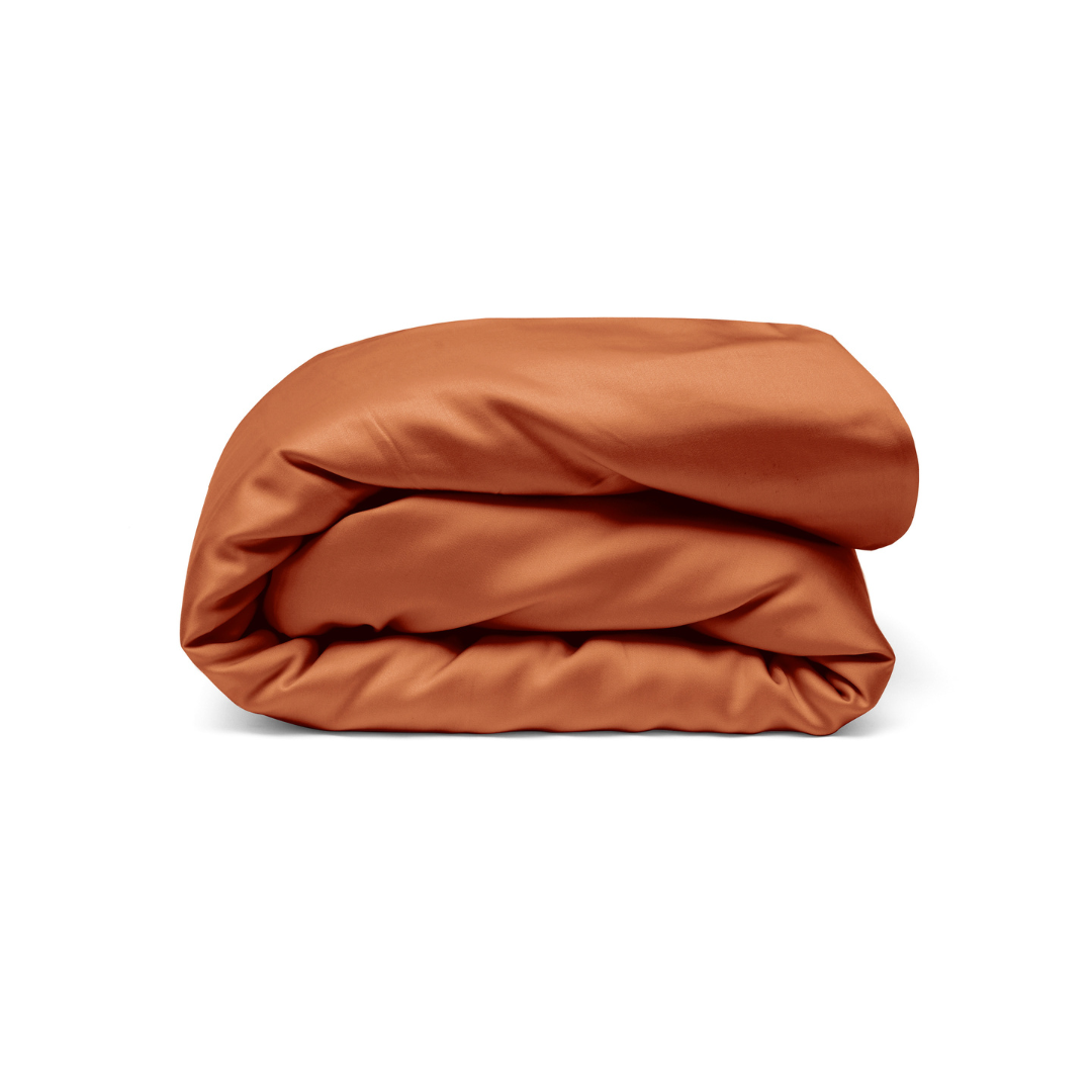 A rust-colored Duvet Cover with antibacterial protection is neatly folded and arranged against a plain white background.