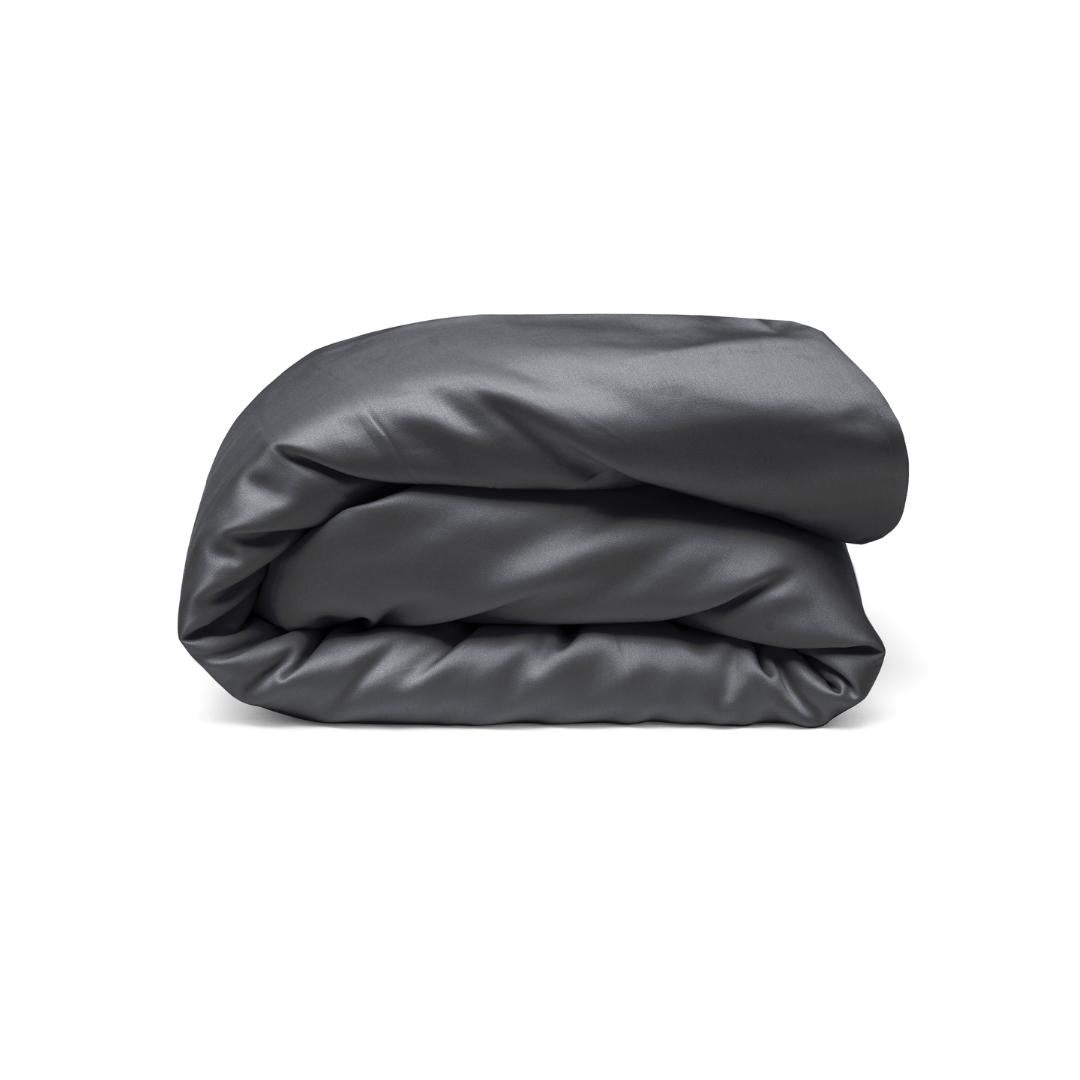 A neatly folded charcoal Duvet Cover, made from sustainable materials, is displayed against a white background.