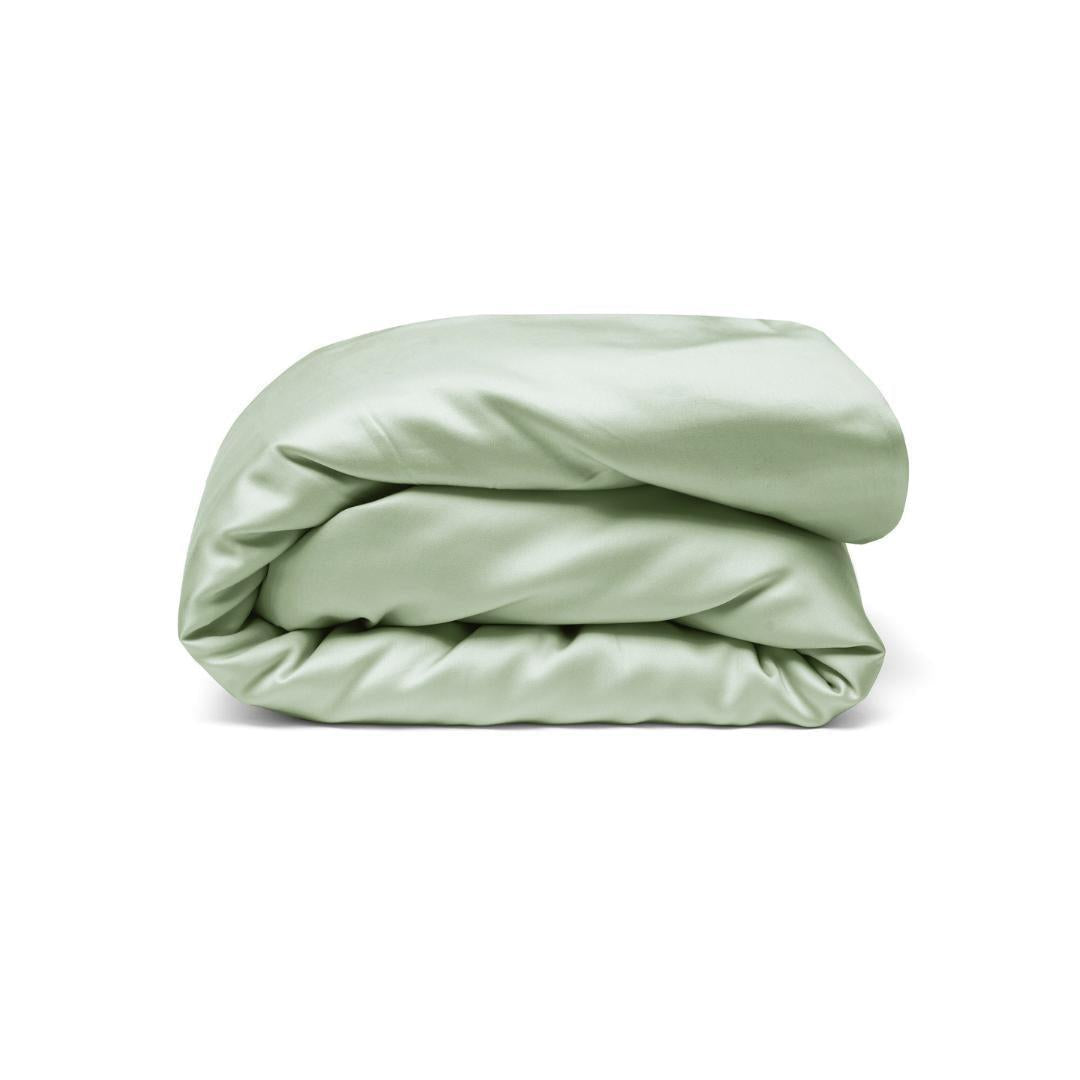 A neatly folded, sage green silky Duvet Cover with antibacterial protection displayed against a plain white background.