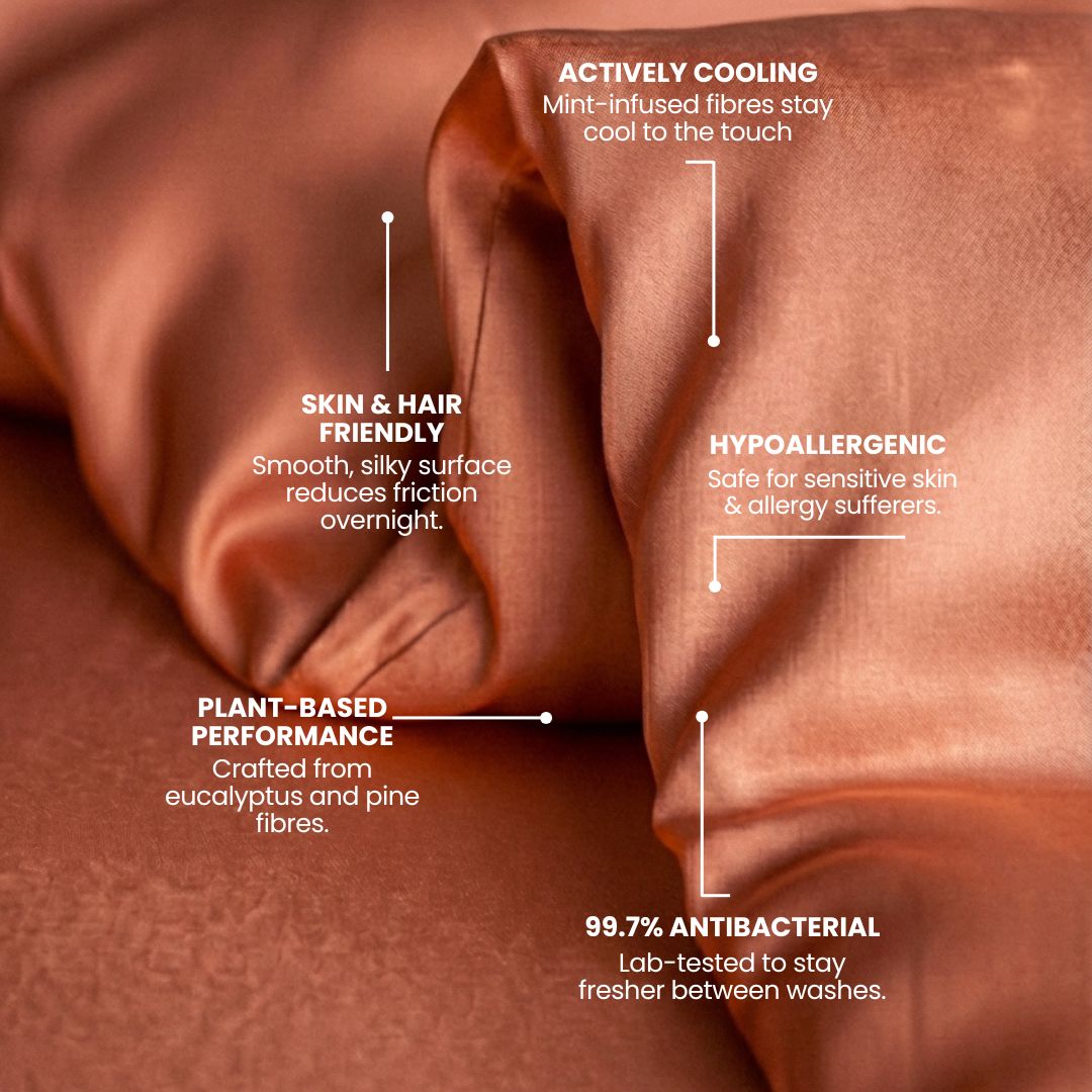 Close-up of terracotta, silky Mynt Lab MyntFusion™ Duvet Cover with labeled features: actively cooling, skin & hair friendly, plant-based performance, hypoallergenic, and 99.7% antibacterial properties.