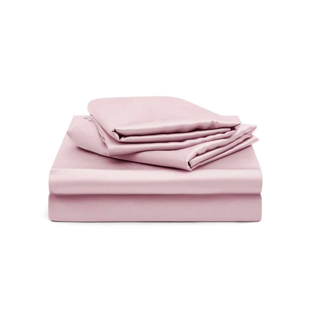 A neatly stacked Fitted Sheet Set (3-Piece) in silky soft, light pink fabric—including a fitted sheet, flat sheet, and pillowcases—displayed on a white background.