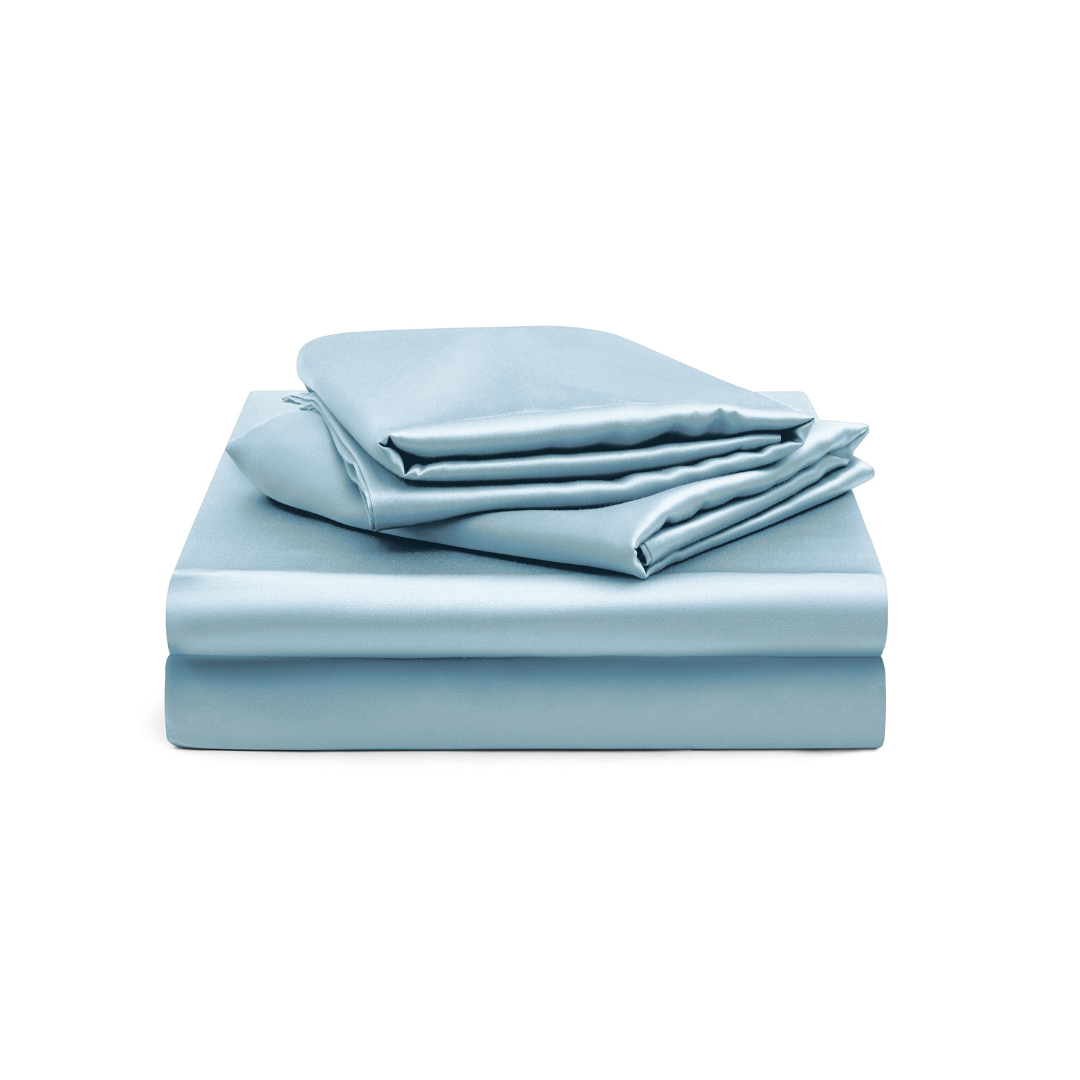 The Fitted Sheet Set, in silky soft light blue, includes a fitted sheet and pillowcases stacked neatly on a white background.