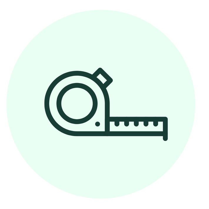 Simple dark green line drawing of a tape measure with the tape partially extended, set against a light mint green circular background.