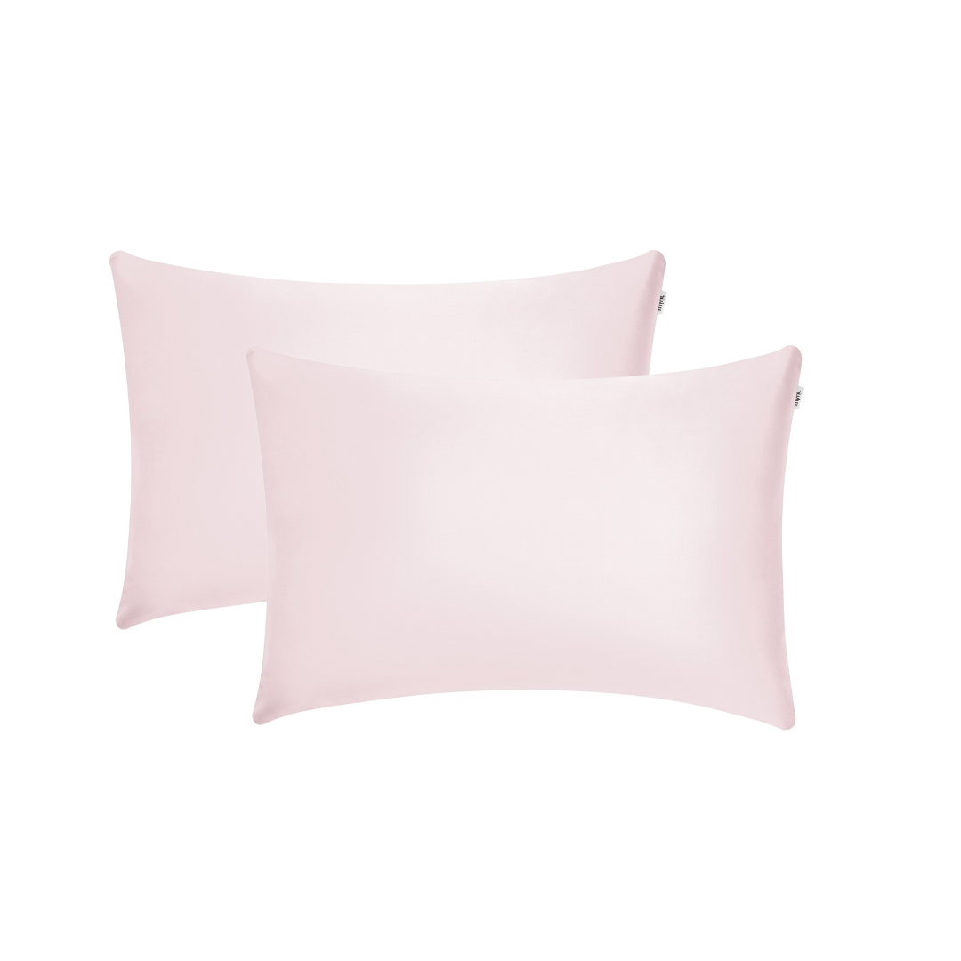 Two light pink satin pillowcases are displayed overlapping slightly against a white background.