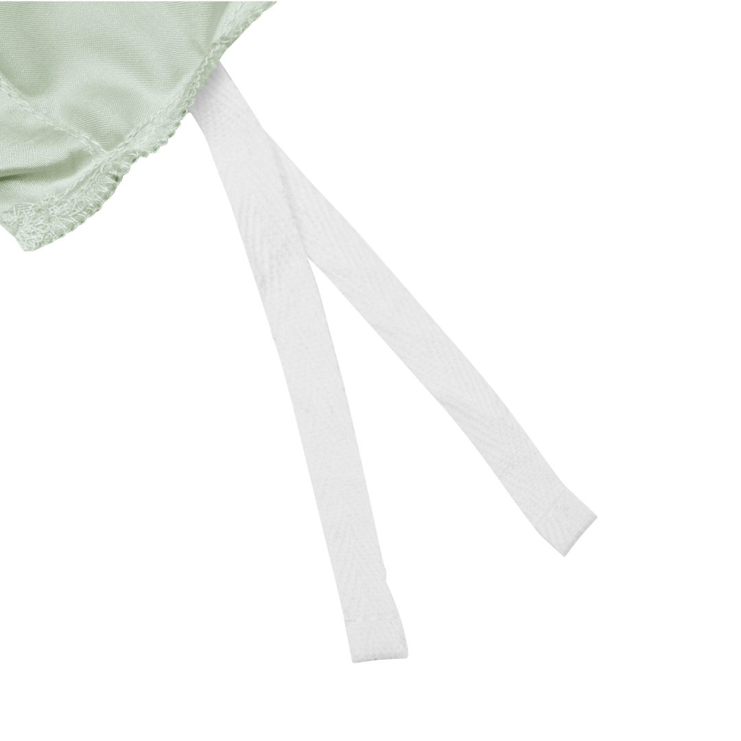 Close-up of a light green fabric with a lace edge, featuring two white fabric straps extending out on a white background.