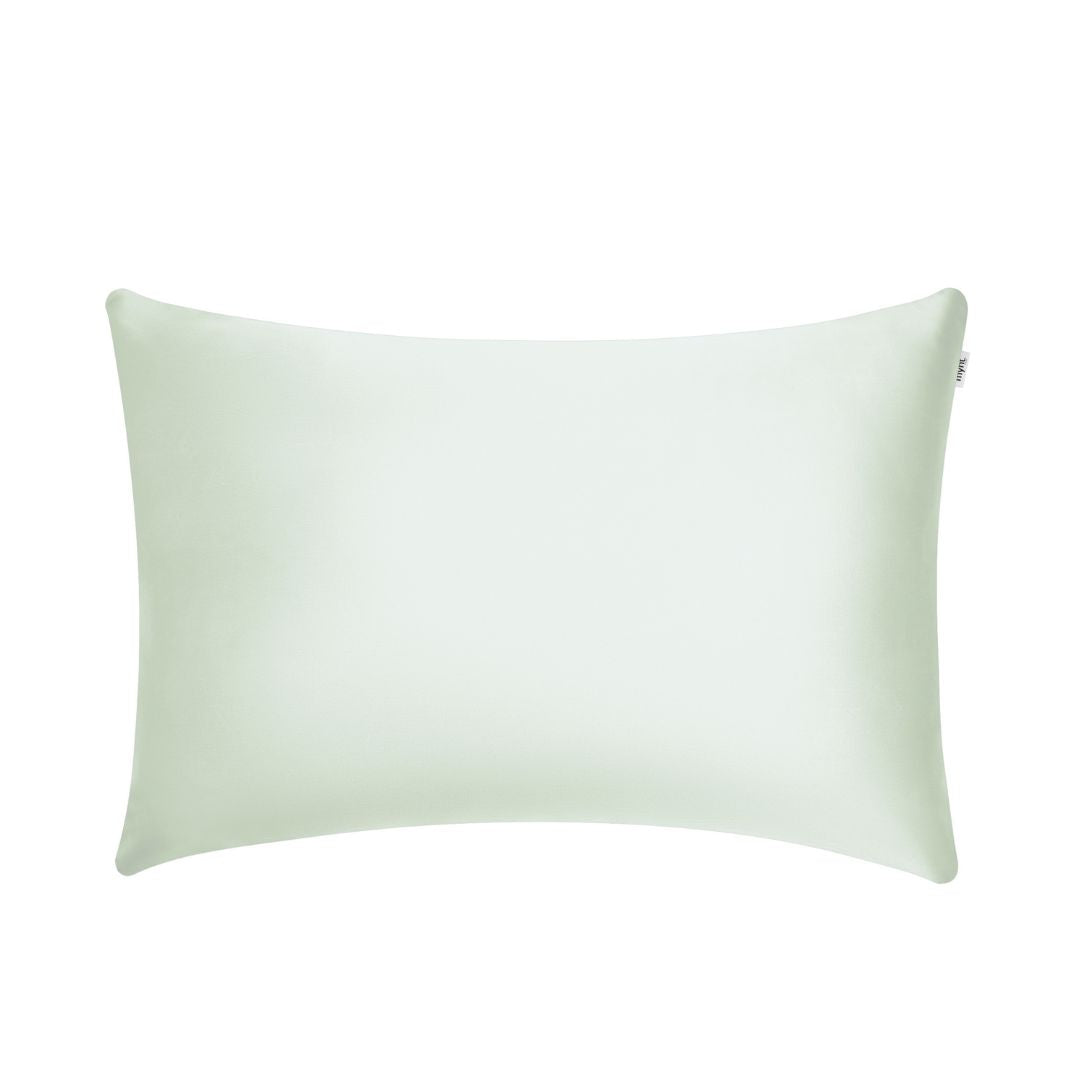A light green rectangular pillowcase with a smooth surface, designed to enhance beauty sleep, displayed against a plain white background.