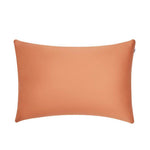 A rectangular, smooth, orange pillow with slightly pointed corners, set against a plain white background.