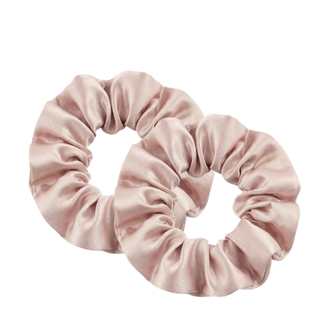 Two pink scrunchies on a white background