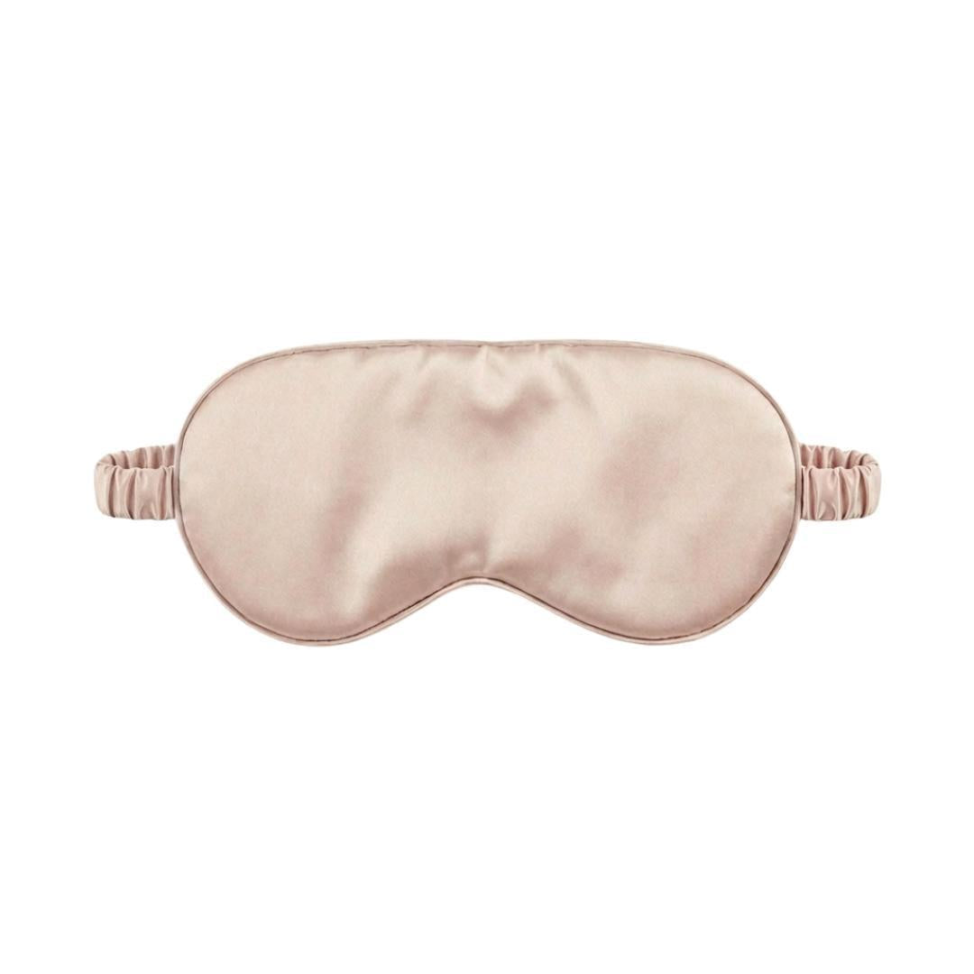 A light pink satin sleep mask with an elasticated band, displayed on a white background.