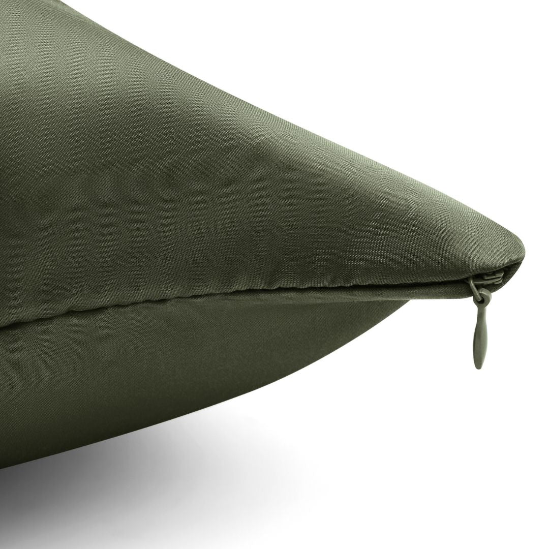 Close-up of the corner of a Mynt Lab olive green Pillowcase with a visible zipper on a white background, designed to promote beauty sleep and help keep your skin hydrated.