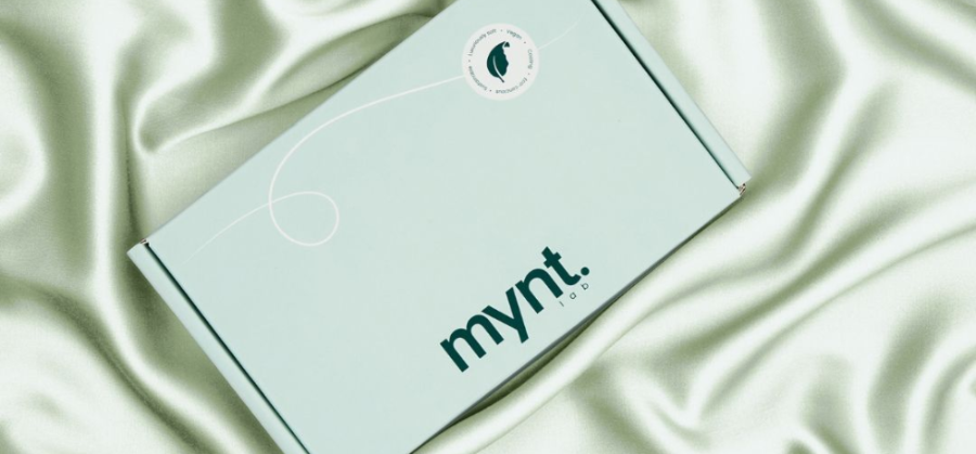 Mint green box with 'mynt lab' branding on a light fabric background