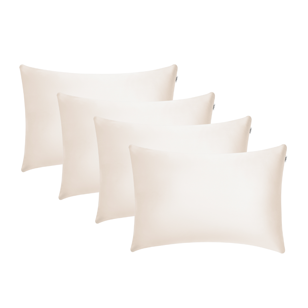 Four sand-coloured rectangular pillowcases arranged in a staggered row on a white background, perfect for beauty sleep and waking up with hydrated skin.