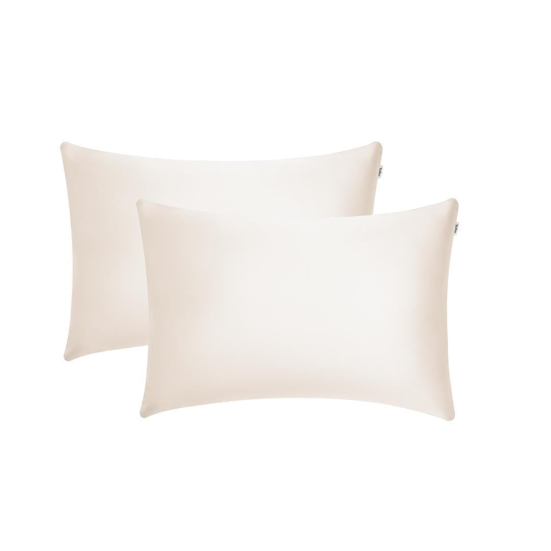 Two sand-coloured rectangular pillowcases with a smooth, silky texture are shown overlapping on a white background - ideal for beauty sleep and reducing frizz.