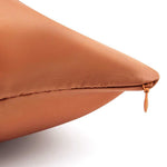 Close-up of Mynt Lab’s rust-colored Pillowcase with visible zipper on a white background. Its textured fabric and pointed corner are shown—ideal for beauty sleep and reducing frizz overnight.