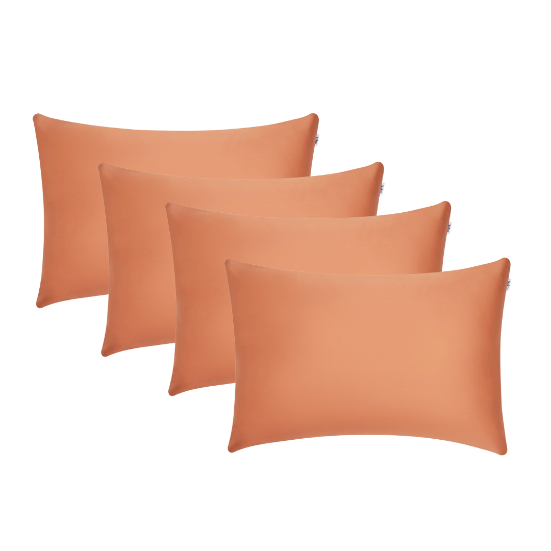Four terracotta rectangular pillowcases are arranged overlapping on a white background, ideal for beauty sleep and reducing frizz overnight.