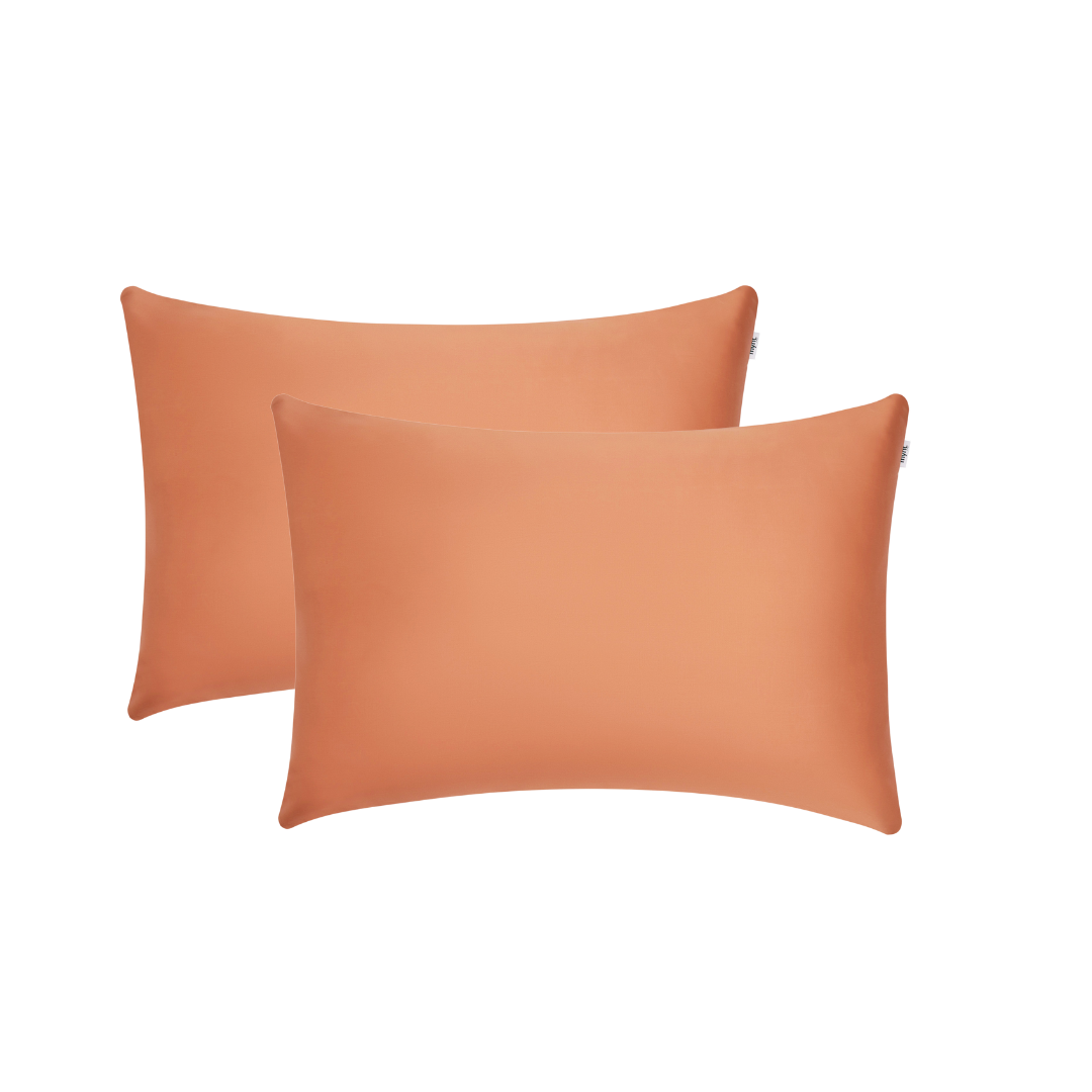 A pair of terracotta rectangular Pillowcases with a smooth, shiny finish are displayed on a plain white background - ideal for beauty sleep and reducing frizz.