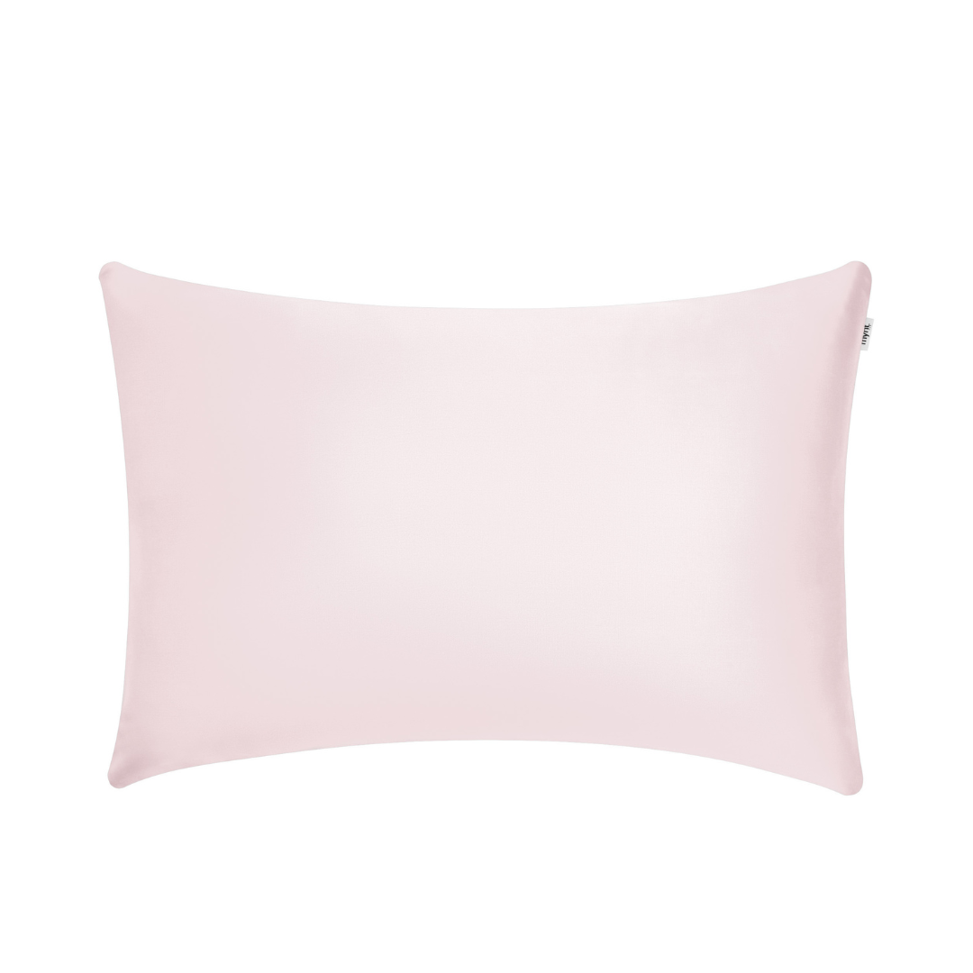 A rectangular, light pink pillow with a smooth texture, shown against a white background.